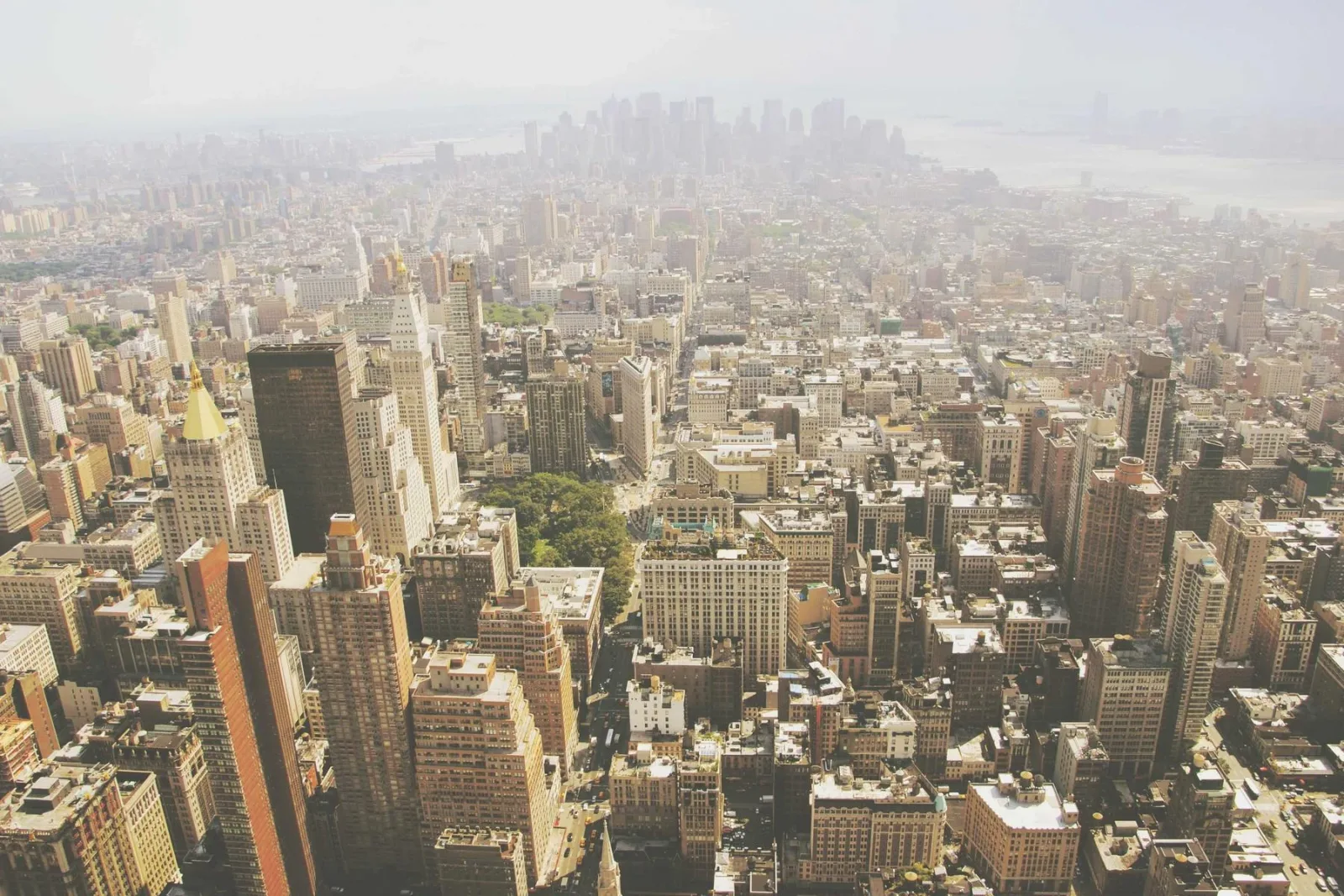 A dense cityscape seen from above in flat daylight